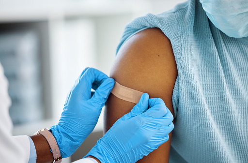 upper arm, hands applying bandage