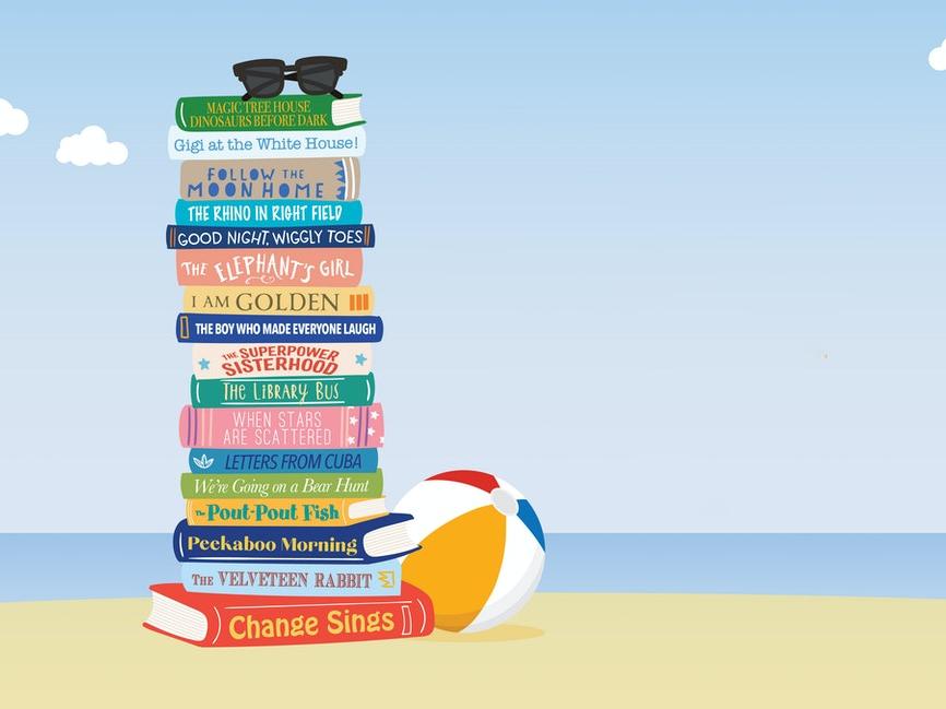 pile of books and beach ball on beach